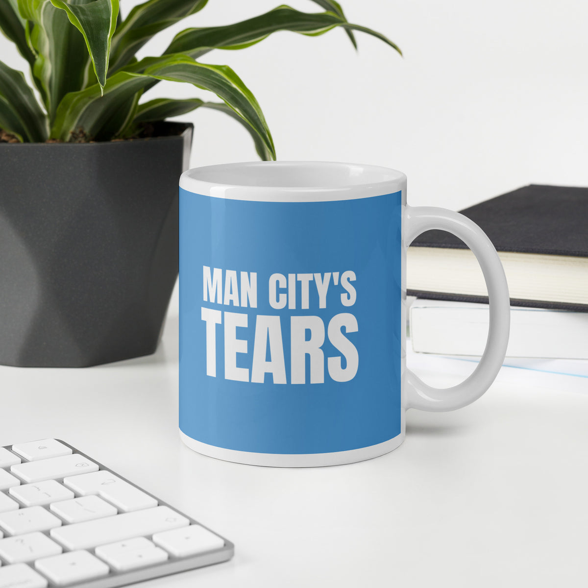 Man smiling with a MAN CITY'S TEARS mug